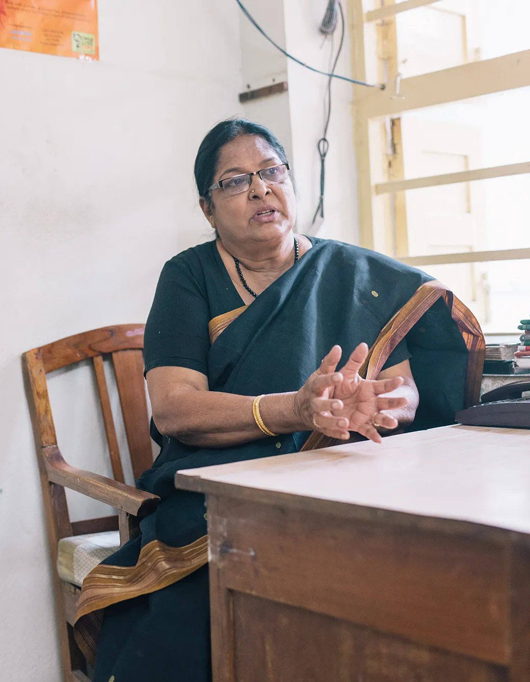 Nanda of SIDUR, an implementing partner of Water.org in India, discusses microfinance solutions at her desk.
